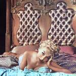 Lili St. Cyr looks very sexy as she is relaxing in bed