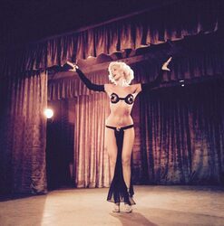 Misty Ayers in a sexy tiny black costume on stage