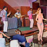Topless dancer in front of the band
