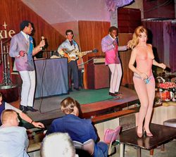 Topless dancer in front of the band