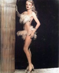 Burlesque artist is wearing only a few feathers Wearing-only-some-feathers