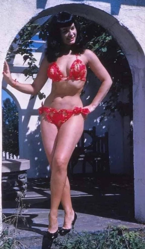 Bettie Page in a red bikini and heels