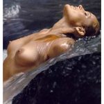 Ursula Andress letting the water run over her