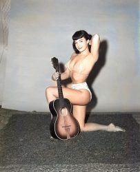 What is Bettie Page ding with that guitar
